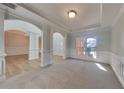 Open living room with light carpet, large windows, and decorative pillars creates an airy feel at 2413 Brynlynn Woods, Conyers, GA 30013