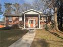 Lovely brick home featuring a columned porch, offering classic charm and curb appeal at 2784 Williamsburg Way, Decatur, GA 30034