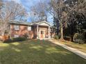 Classic brick home with a welcoming front porch and meticulously maintained lawn at 2784 Williamsburg Way, Decatur, GA 30034