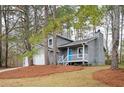 Charming two-story home featuring a blue front door and a two-car garage at 3201 Palomino Dr, Powder Springs, GA 30127