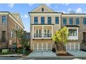 Charming two-story townhome with brick facade, second story balcony, and a two car garage at 235 Briscoe Way # 7, Alpharetta, GA 30009