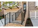 Stairway leading to the front door and second story balcony of a brick townhome with two car garage at 235 Briscoe Way # 7, Alpharetta, GA 30009