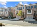 Modern brick townhomes with two car garages, second story balconies, and well-maintained landscaping at 235 Briscoe Way # 7, Alpharetta, GA 30009