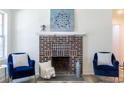 Close-up of fireplace with decorative brickwork and stylish seating area at 2949 Pearl St, East Point, GA 30344