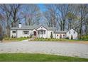 Charming white-painted brick home with a manicured lawn and a gravel driveway at 4900 College St, Union City, GA 30291