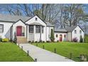Charming white painted brick home featuring manicured landscaping and a lovely front yard at 4900 College St, Union City, GA 30291