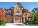 Beautiful two-story home with brick and stone exterior, two-car garage and well manicured landscaping at 5860 Bluff Heights Drive, Cumming, GA 30040