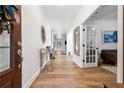 Bright foyer with hardwood floors, white walls, and decorative mirror and table at 5860 Bluff Heights Drive, Cumming, GA 30040