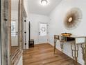 Bright foyer with hardwood floors, white walls, and decorative mirror and table at 5860 Bluff Heights Drive, Cumming, GA 30040