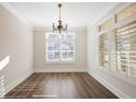 Bright dining room with large windows, shutters and stylish hardwood floors at 1011 Stillington Way, Kennesaw, GA 30152