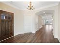 Inviting foyer with dark wood door that opens to the main living area and hardwood floors at 1011 Stillington Way, Kennesaw, GA 30152