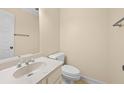 Powder room featuring a white toilet and vanity with an oval sink at 303 Brandywine Cir, Atlanta, GA 30350