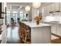 Open kitchen features a white marble island, stainless appliances, and pendant lighting at 45 Honour Nw Ave, Atlanta, GA 30305