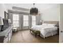 Relaxing bedroom with neutral tones, tray ceiling, and large windows at 45 Honour Nw Ave, Atlanta, GA 30305