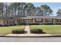 Traditional brick home with a manicured lawn and mature trees, providing a serene setting at 3346 Stonecrest Ct, Atlanta, GA 30341
