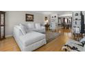 Cozy living room with hardwood floors and a comfortable white sectional sofa at 3346 Stonecrest Ct, Atlanta, GA 30341