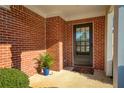 Close up of the front entry and door showcasing beautiful brickwork and a manicured plant at 4071 Cottage Oaks Dr # 3, Acworth, GA 30101