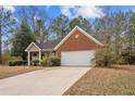 Inviting one-story home showcasing brick and siding exterior, manicured shrubs, and an attached two-car garage at 2279 Perch Sw Way, Marietta, GA 30008