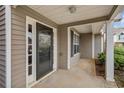 Covered front porch with gray siding and a decorative front door and sidelights at 2279 Perch Sw Way, Marietta, GA 30008