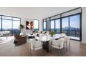 Living room and dining area with floor-to-ceiling windows showcasing a stunning city skyline at 2425 Peachtree Ne Rd # 1705, Atlanta, GA 30305