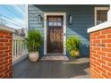 Close up of a welcoming front porch with plants and a dark wood front door at 243 Sterling St, Decatur, GA 30030