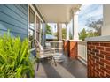 Inviting front porch with brick columns, white railing, and comfortable seating at 243 Sterling St, Decatur, GA 30030