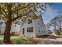 Charming two-story white home with black framed windows and mature tree at 3395 Lee St, East Point, GA 30344