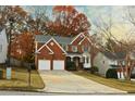 Inviting two-story brick home with a two-car garage and mature trees in a quiet neighborhood at 912 Tanners Point Dr, Lawrenceville, GA 30044