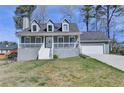 Charming home featuring a welcoming front porch, well-maintained lawn, and attached two-car garage at 1001 Pine Ridge Dr, Stone Mountain, GA 30087