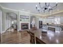 Open-concept living and dining space showcases hardwood floors, a cozy fireplace, and abundant natural light at 2160 Kensington Gates Nw Dr, Kennesaw, GA 30152