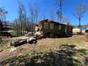 Side view of a damaged house with debris and exposed sections, showcasing the extent of needed repairs or demolition at 3440 Corral Dr, Marietta, GA 30066