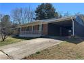 A single-story brick home featuring a convenient, attached carport for covered parking at 726 Shoreline Se Trl, Conyers, GA 30094