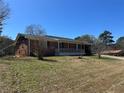 Quaint single-story brick home featuring a covered front porch, set on a spacious lot at 726 Shoreline Se Trl, Conyers, GA 30094