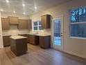 Modern kitchen with stainless steel appliances, granite countertops, and a view to the backyard at 220 Bloomfield Cir, Canton, GA 30114