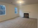 Bright and open living room with large windows and a cozy fireplace at 220 Bloomfield Cir, Canton, GA 30114