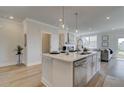 Contemporary kitchen showcasing an island with seating, stainless steel appliances, and modern fixtures at 254 Depot Landing Rd # 55, Auburn, GA 30011