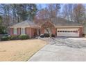 Charming brick ranch-style home with lush landscaping and an attached two-car garage at 549 Trailwood Sw Ln, Marietta, GA 30064