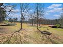 Lush backyard featuring a fire pit, above ground pool, storage shed, and open space for outdoor activities at 1875 Ebenezer Sw Rd, Conyers, GA 30094