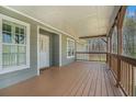 Inviting covered porch with wood decking and railing, perfect for outdoor relaxation and enjoying the surrounding views at 1875 Ebenezer Sw Rd, Conyers, GA 30094