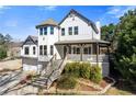 Two-story home with front-facing gables, prominent front tower, landscaped yard and multi-level front entry staircase at 695 Old Peachtree Rd, Lawrenceville, GA 30043