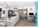 Open-concept living room with hardwood floors, fireplace, and views into the kitchen and dining areas at 710 Josh Ln, Lawrenceville, GA 30045