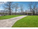 Ranch-style home with a well-kept lawn and a lengthy driveway on a sunny day at 2518 Crestdale Se Cir, Atlanta, GA 30316