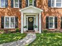 Close up of the front entrance with a decorated door, a walkway, and well-kept garden at 745 Princeton Mill Run, Marietta, GA 30068