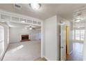 Open-concept living room with a brick fireplace and large windows allowing ample light at 921 Dunagan Way, Lawrenceville, GA 30045