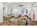 Bright living room featuring hardwood floors, a ceiling fan, and a view to the home's front yard at 1090 Indale Sw Pl, Atlanta, GA 30310