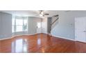 Open-concept living area features hardwood floors, staircase access, and abundant natural light from the bay window at 2877 Deerwood Sw Dr, Atlanta, GA 30331
