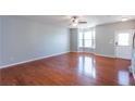 Spacious living room with gleaming hardwood floors and natural light from a large bay window at 2877 Deerwood Sw Dr, Atlanta, GA 30331
