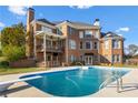 Backyard with a beautiful in-ground swimming pool, a covered porch, and well-maintained landscaping at 100 Annes Ln, Sharpsburg, GA 30277