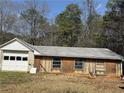 Exterior view of a detached garage or outbuilding needing renovation at 3153 Lake Monroe Rd, Douglasville, GA 30135