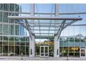 A striking building entrance featuring a glass canopy and well-manicured landscaping at 3324 Peachtree Ne Rd # 1510, Atlanta, GA 30326
